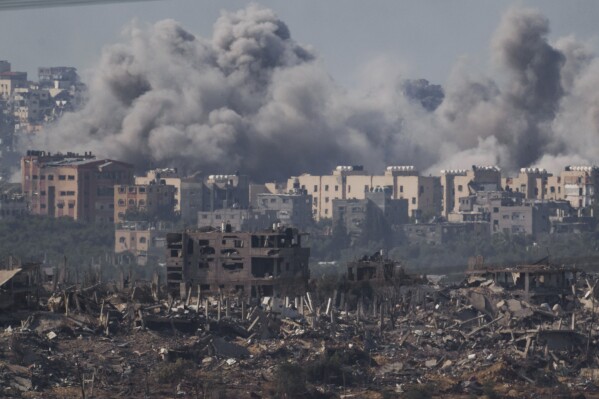 Smoke rises following an Israeli airstrike in the Gaza Strip, as seen from southern Israel, Tuesday, Nov. 21, 2023. (AP Photo/Leo Correa)