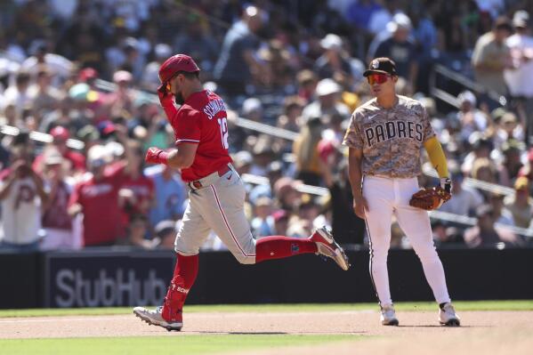 Philadelphia Phillies' Kyle Schwarber, background center, celebrates with  Matt Vierling (19) and Bryson Stott (5) after hitting a three run home run  against San Diego Padres' Nabil Crismatt in the seventh inning