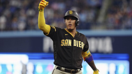 San Diego Padres' Manny Machado celebrates his two-run single against the Toronto Blue Jays during the fifth inning of a baseball game Wednesday, July 19, 2023, in Toronto. (Chris Young/The Canadian Press via AP)