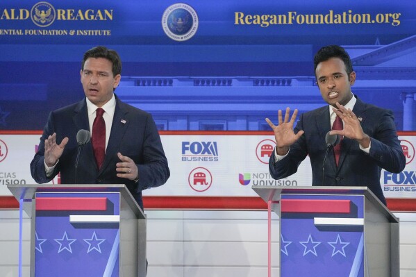 Republican presidential candidates, Florida Gov. Ron DeSantis, left, and entrepreneur Vivek Ramaswamy, right, both speaking during a Republican presidential primary debate hosted by FOX Business Network and Univision, Wednesday, Sept. 27, 2023, at the Ronald Reagan Presidential Library in Simi Valley, Calif. (AP Photo/Mark Terrill)