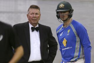 FILE - Australia's chairman of selectors Rod Marsh, left, talks with cricket captain Steve Smith during training in Adelaide ahead of their cricket test against New Zealand on Nov. 25, 2015. Marsh, an Australian cricket great and the wicketkeeper who formed a prolific wicket-taking partnership with pace bowler Dennis Lillee, has died, Friday, March 4, 2022, a week after suffering a heart attack. He was 74. (AP Photo/Rick Rycroft, File)