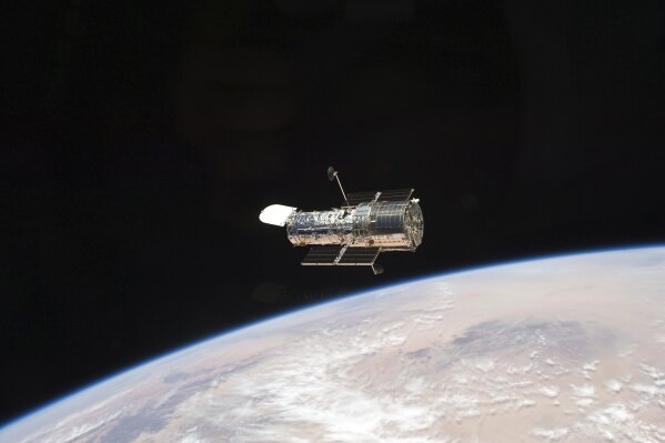 This photo provided by NASA, an STS-125 crew member aboard the Space Shuttle Atlantis captured this image of NASA’s Hubble Space Telescope on May 19, 2009. NASA said the telescope slipped into a hibernating state more than a week ago when one of its gyroscopes _ part of the pointing system _ malfunctioned. The same device has been acting up for months and disrupting scientific operations. Hubble remains safe but inactive as flight controllers figure out how to proceed, officials said. The space agency planned to outline a path forward on Tuesday, June 4, 2024.(NASA via AP)