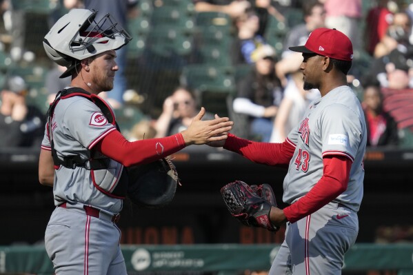 Cincinnati Reds catcher Tyler Stephenson, left, celebrates with relief pitcher Alexis Díaz, right, after they defeated the Chicago White Sox in a baseball game in Chicago, Sunday, April 14, 2024. (AP Photo/Nam Y. Huh)