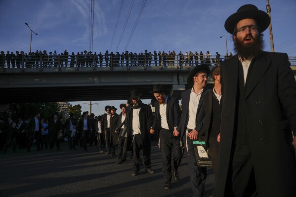 Ultra-Orthodox Jewish men block a highway during a protest against army recruitment in Bnei Brak, Israel, on March 2, 2025. (AP Photo/Ohad Zwigenberg, File)