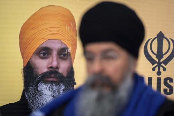 A photo of Hardeep Singh Nijjar is seen during a news conference providing an update from the Sikh community about Nijjar's homicide from June 18, 2023 in Surrey, B.C. on Friday, May 3, 2024. (Ethan Cairns/The Canadian Press via Ǻ)