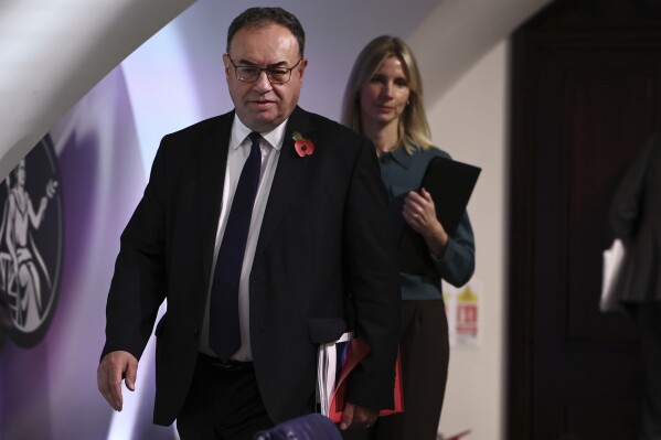 Governor of the Bank of England Andrew Bailey arrives to address the media during a press conference concerning interest rates, at the Bank of England, in London, Thursday, Nov. 2, 2023. The Bank of England kept its main interest rate unchanged on Thursday at the 15-year high of 5.25% and indicated that borrowing costs will likely remain at these sort of elevated levels for a while, especially if oil and gas prices increase sharply in light of the conflict between Israel and Hamas. (Henry Nicholls/Pool Photo via AP)