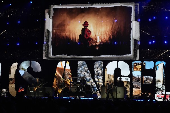 Billie Joe Armstrong, from left, Tre Cool, and Mike Dirnt of Green Day perform during the FireAid benefit concert on Thursday, Jan. 30, 2025, at The Forum in Inglewood, Calif. (AP Photo/Chris Pizzello)