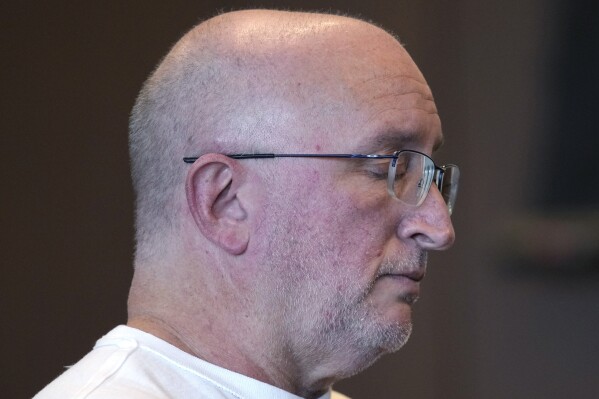 Robert E. Crimo Jr., closes his eyes as he listens to Judge George D. Strickland at the Lake County Courthouse, Wednesday, Nov. 15, 2023, in Waukegan, Ill. Crimo Jr., the father of the suspect in a deadly Fourth of July parade shooting in suburban Chicago turned himself in Wednesday to begin a 60-day jail sentence, after pleading guilty to charges arising from his sponsorship of his son's application for a gun license. (AP Photo/Nam Y. Huh, Pool)