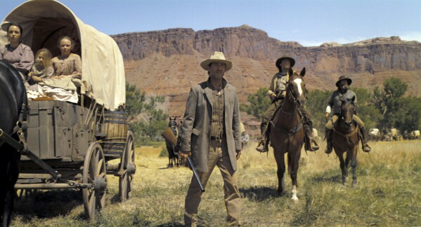 This image released by Warner Bros. Pictures shows Luke Wilson, center, in a scene from "Horizon: An American Saga - Chapter 1." (Warner Bros. Pictures via AP)