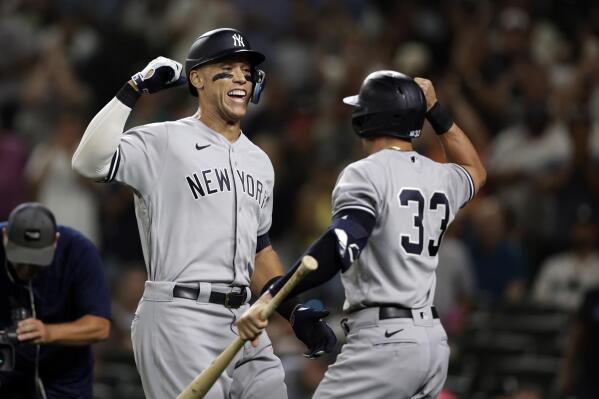 New York Yankees' Aaron Judge celebrates with Tim Locastro after hitting a solo home run on a pitch from Seattle Mariners' Ryan Borucki during the ninth inning of a baseball game, Monday, Aug. 8, 2022, in Seattle. (AP Photo/John Froschauer)