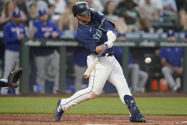Seattle Mariners' Ty France hits a solo home run against the Texas Rangers during the fifth inning of a baseball game, Monday, July 25, 2022, in Seattle. (AP Photo/Ted S. Warren)