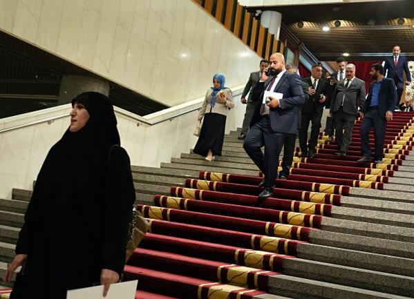 Lawmakers prepare to attend a parliament session in Baghdad, Iraq, Thursday, Jun. 23, 2022. Iraq’s Parliament is set to hold a session Thursday to vote in replacements for 73 lawmakers who resigned earlier this month. The collective walkout by followers of Muqtada al-Sadr, Iraq’s most influential Shiite politician, threw Iraq into further uncertainty, deepening a months-long political crisis over government formation. (AP Photo/Hadi Mizban)