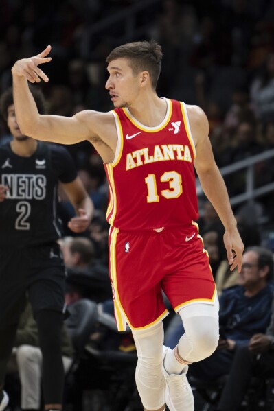 Atlanta Hawks guard Bogdan Bogdanovic reacts after making a three pointer during the first half of an NBA basketball game against the Brooklyn Nets, Wednesday, Nov. 22, 2023, in Atlanta. (AP Photo/Hakim Wright Sr.)