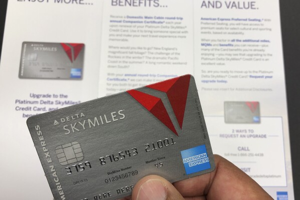 FILE - A direct mail advertisement for American Express is shown in Miami, Oct. 29, 2019. American Express is rolling out several updates Thursday, Feb. 1, 2024, to its Delta SkyMiles credit cards that will give additional benefits to users. AmEx is eager to soothe sore Delta Air Lines customers who have considered abandoning the airline after last year’s SkyMiles loyalty fiasco. (AP Photo/Wilfredo Lee, File)