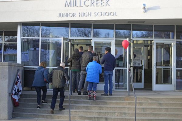 People line up during the Republican caucus at the Millcreek Junior High School on Tuesday, March 5, 2024, in Bountiful, Utah. Republican voters gathered at neighborhood precincts across Utah on Super Tuesday to select a presidential nominee through an in-person candidate preference poll. (AP Photo/Rick Bowmer)