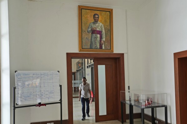FILE -- The painting of Nobel Peace Prize winner Bishop Carlos Ximenes Belo is displayed at the Timorese Resistance Museum in Dili, East Timor, Aug. 13, 2024. (AP Photo/Achmad Ibrahim, File)