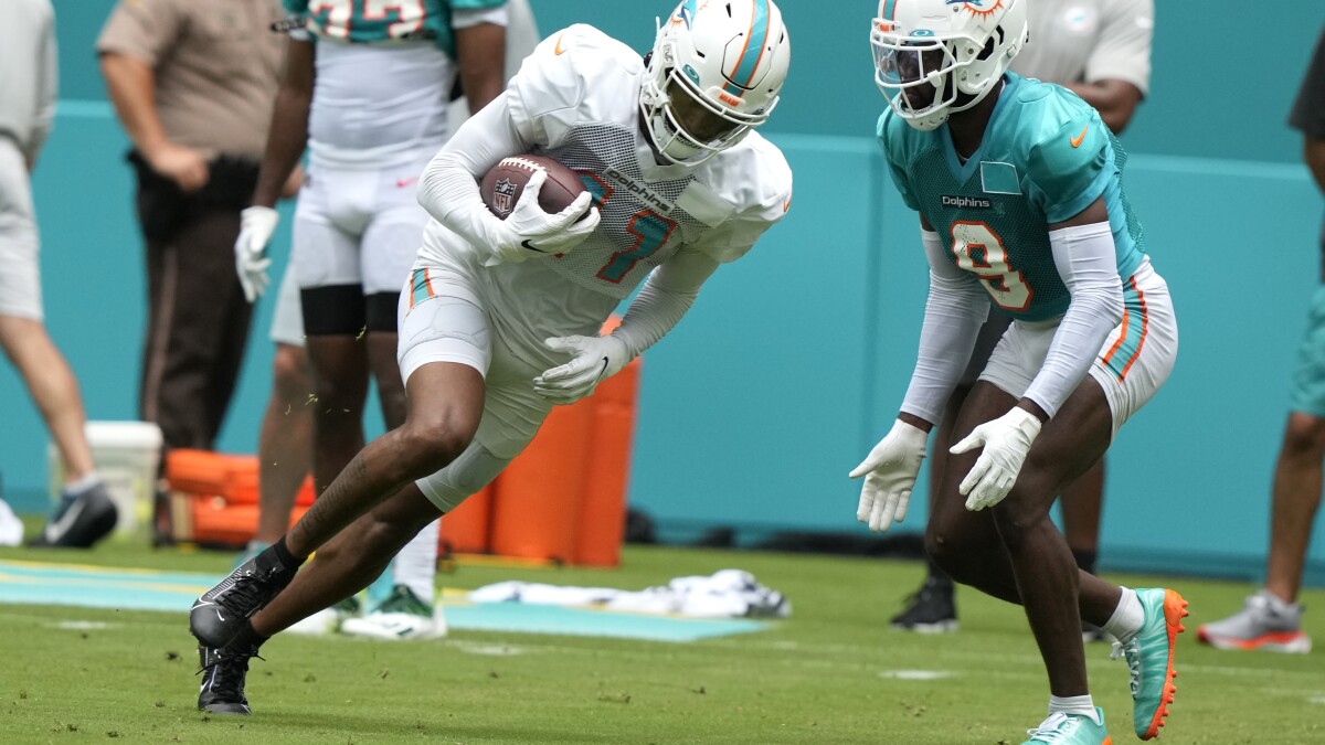 Miami Dolphins safety Jevon Holland, left, and cornerback Jalen