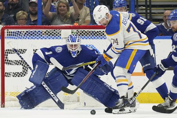 Tampa Bay Lightning goaltender Brian Elliott (1) keeps an eye on the puck as Buffalo Sabres center Rasmus Asplund (74) and Lightning center Steven Stamkos (91) battle for control during the second period of an NHL hockey game Sunday, April 10, 2022, in Tampa, Fla. (AP Photo/Chris O'Meara)