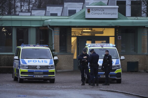 Police officers are standing guards near the scene of a shooting at an adult education centre on Wednesday, February 5, 2025, at the outskirts of Orebro, Sweden (AP Photo/Sergei Grits).