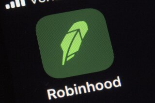 This Thursday, Dec. 17, 2020 photo shows the logo for the Robinhood app on a smartphone in New York. Robinhood Financial agreed to pay $65 million to settle government charges that it failed to disclose the full details of its dealings with high-speed traders and didn't get the best prices for customers trading on its app, the Securities and Exchange Commission said Thursday. (AP Photo/Patrick Sison)