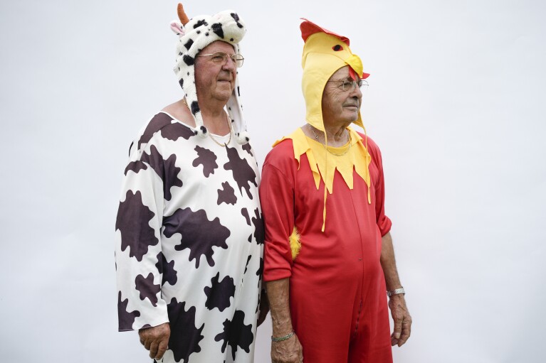 Roger Soreau, left, and Fernand Despeignes pose for a portrait wearing their costumes during the fourth stage of the Tour de France cycling race over 182 kilometers (113 miles) with start in Dax and finish in Nogaro, France, Tuesday, July 4, 2023. (AP Photo/Daniel Cole)