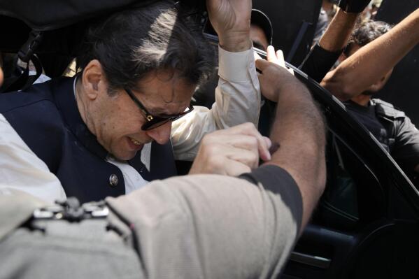 Former Pakistani Prime Minister Imran Khan, arrives to appear before a court in Lahore, Pakistan, Friday, May 19, 2023. Khan dialed down his campaign of defiance Friday, saying he would allow a police search of his residence over allegations he was harboring suspects wanted in recent violence and appearing before a court in his hometown to seek protection from arrest in multiple terrorism cases. (AP Photo/K.M. Chaudary)