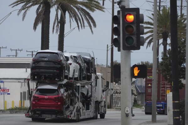 New Mazda SUVs are transported at the Port of Long Beach in Long Beach, Calif., Wednesday, March 26, 2025. (AP Photo/Damian Dovarganes)