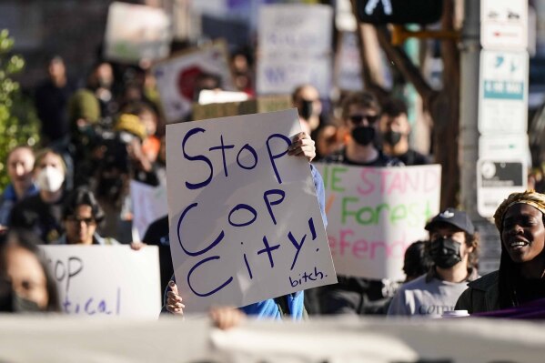 Demonstrators march to the courthouse supporting 61 defendants that are being arraigned on RICO charges related to vandalism at the site of the new Public Safety Training Center, outside the a Fulton County courthouse, Monday, Nov. 6, 2023, in Atlanta. (AP Photo/Mike Stewart)