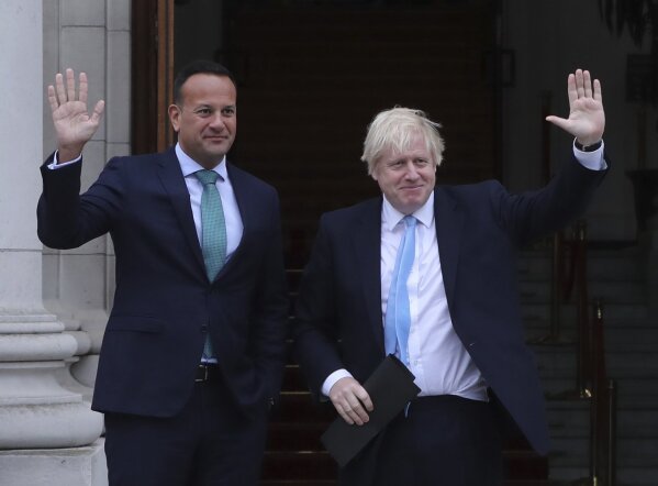 Britain's Prime Minister Boris Johnson, right, and Ireland's Prime Minister Leo Varadkar wave at Government Buildings in Dublin, Monday Sept. 9, 2019. Boris Johnson is to meet with Leo Varadkar in search of a compromise on the simmering Brexit crisis. (Niall Carson/PA via AP)