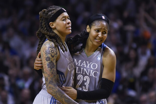 FILE - Minnesota Lynx guard Seimone Augustus (33) and forward Maya Moore (23) embrace after Game 5 of the team's WNBA Finals against the Los Angeles Sparks, Oct. 4, 2017 in Minneapolis. The Women’s Basketball Hall of Fame had a huge Minnesota feel to it with the induction of Moore and Augustus getting enshrined on Saturday, April 25, 2024. (Aaron Lavinsky/Star Tribune via AP, File)