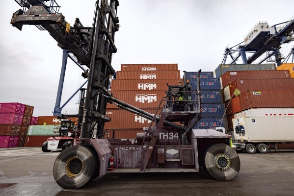 A top-handler drives in the Yusen Terminal at the Port of Los Angeles, Tuesday, March 11, 2025, in San Pedro, Calif. (AP Photo/Etienne Laurent)