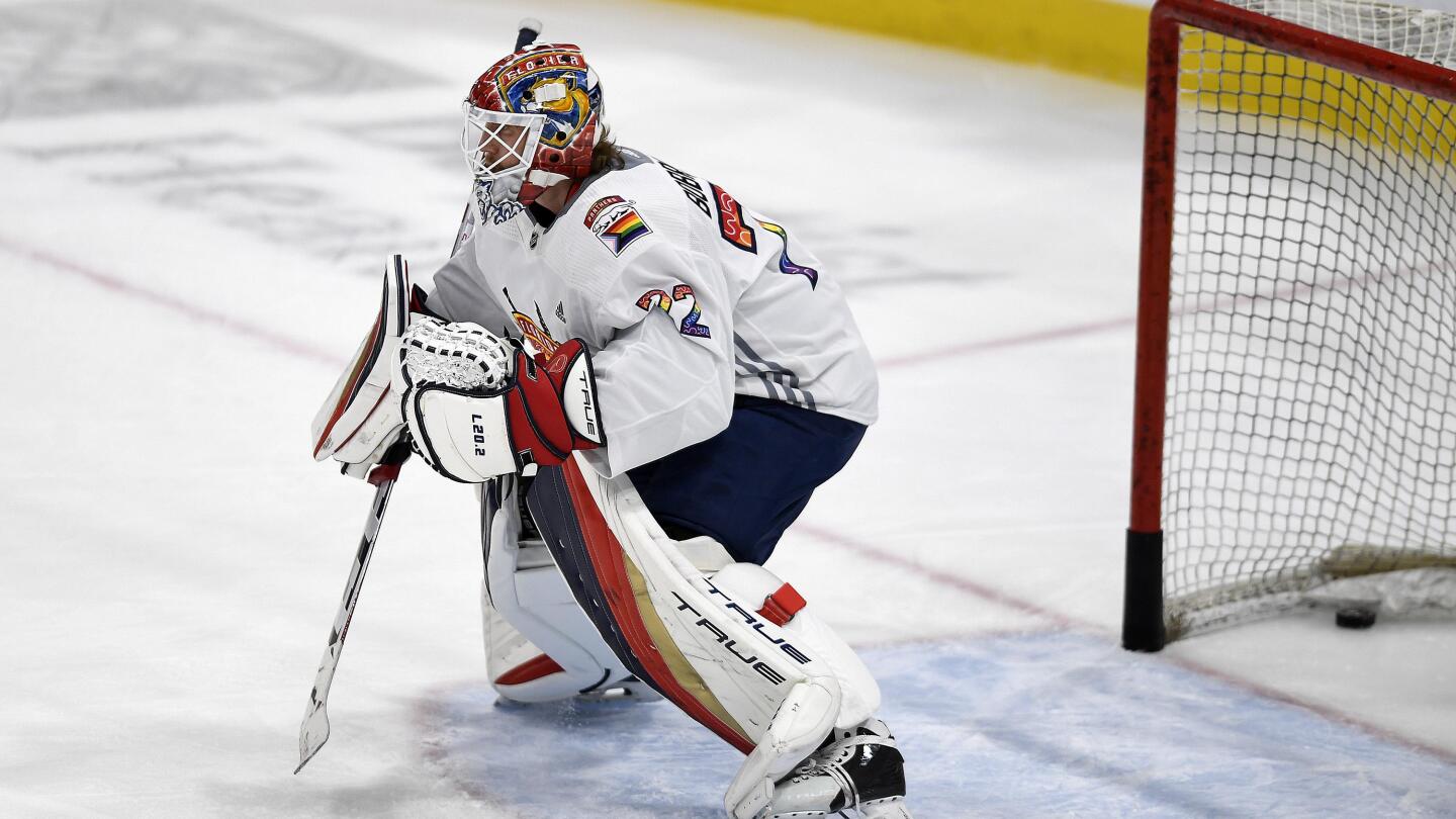 FILE - Los Angeles Kings goaltender Calvin Petersen (40) wears a  Pride-themed jersey and holds a stick wrapped in rainbow tape for Pride  night while warming up before an NHL hockey game