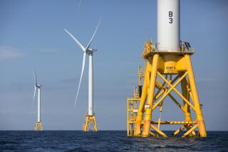 FILE - In this Aug. 15, 2016 file photo, three of Deepwater Wind's five turbines stand in the water off Block Island, R.I. On June 3, 2021, Atlantic Shores Offshore Wind announced a study with Rutgers University and the New Jersey clam industry of how offshore wind energy projects might impact the clam industry over the next 30 years.(AP Photo/Michael Dwyer, File)