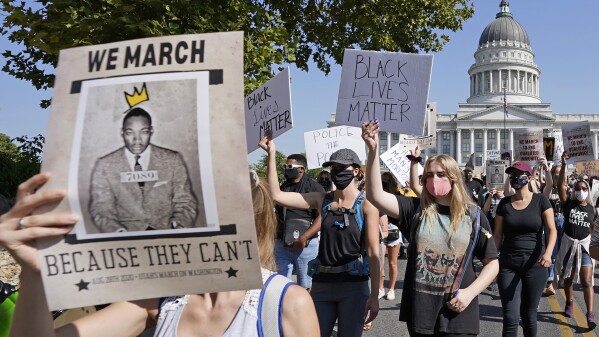 FILE - Hundreds march during a "March on Washington" rally, Friday, Aug. 28, 2020, in Salt Lake City. Marchers gathered on the 57th anniversary of the Rev. Martin Luther King Jr.'s "I Have A Dream" speech. (AP Photo/Rick Bowmer, File)
