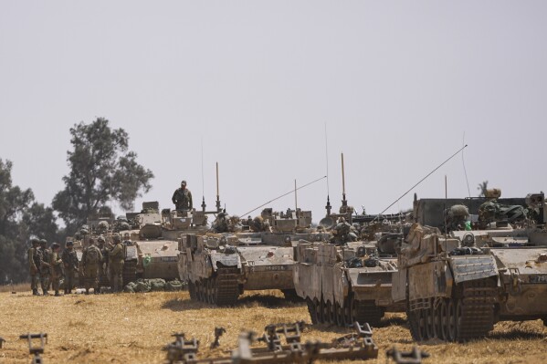 Israeli soldiers are seen at a staging ground near the border with the Gaza Strip, in southern Israel, Wednesday, May 1, 2024. (AP Photo/Ohad Zwigenberg)