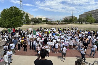 Oklahoma City immigration attorney Sam Wargin Grimaldo speaks to a group outside the Oklahoma Capitol on Tuesday, April 23, 2024, who opposed a bill that would impose criminal penalties to be in the state illegally. Oklahoma is one of several GOP-led states seeking to give broader immigration enforcement powers to local police. (AP Photo/Sean Murphy)