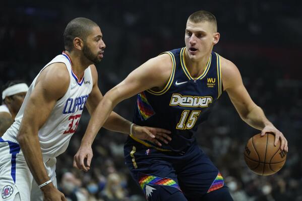 Los Angeles Clippers forward Nicolas Batum (33) defends against Denver Nuggets center Nikola Jokic (15) during the first half of an NBA basketball game in Los Angeles, Sunday, Dec. 26, 2021. (AP Photo/Ashley Landis)