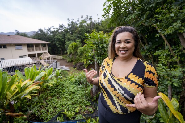 Mailani Makainai, great-great-granddaughter of Hamana Kalili who is known as the father of shaka, flashes a shaka at her home on Wednesday, March 6, 2024, in Kaneohe, Hawaii. (AP Photo/Mengshin Lin)