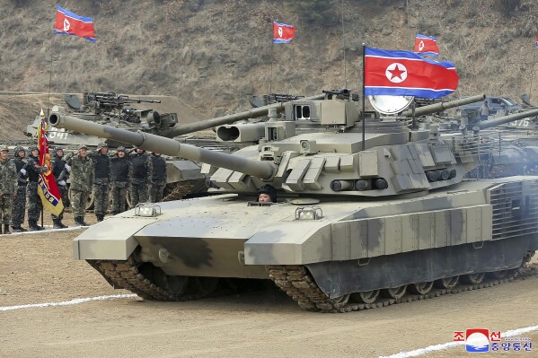 In this photo provided by the North Korean government, North Korean leader Kim Jong Un drives a new-type tank in North Korea Wednesday, March 13, 2024. Independent journalists were not given access to cover the event depicted in this image distributed by the North Korean government. The content of this image is as provided and cannot be independently verified. Korean language watermark on image as provided by source reads: "KCNA" which is the abbreviation for Korean Central News Agency. (Korean Central News Agency/Korea News Service via AP)