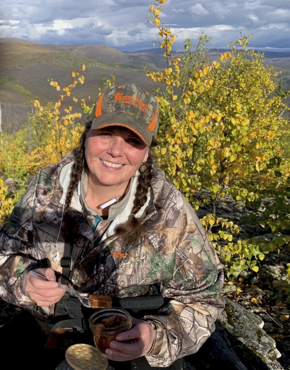 This Sept. 2023 photo shows Alaska resident Cynthia Erickson shown on a hunting trip near Tanana, Alaska. Erickson says the $1,312 dividend check that most Alaskans will receive this fall won't stretch far in her rural community, where costs for goods and necessities are high, but she says it will help. (Dale Erickson via AP)