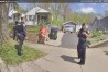 This image made from Fairfield Township, Ohio, Police Department body camera video shows Ann Mayers waiting outside of her home with police on Friday, April 19, 2024, in Hamilton, Ohio. The 74-year-old woman charged in the armed robbery of an Ohio credit union last week is a victim of an online scam who may have been trying to solve her financial problems, according to her relatives. Mayers, who had no previous run-ins with the law, faces counts of aggravated robbery with a firearm and tampering with evidence in Friday's robbery in Fairfield Township. (Fairfield Township Police Department via AP)