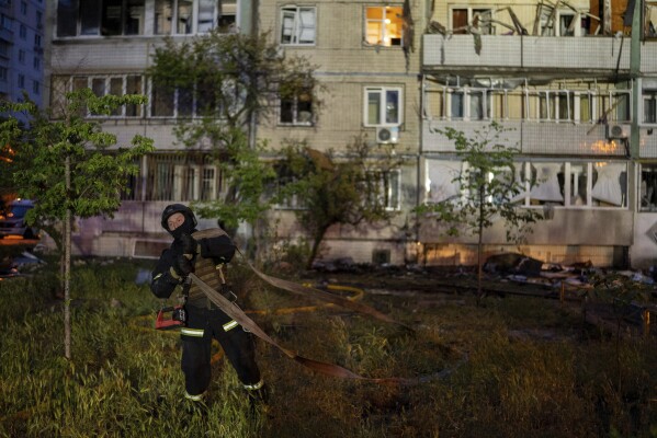 A firefighter works on the site of a residential building damaged after a Russian attack in Kyiv, Ukraine, Saturday, May 24, 2025. (AP Photo/Alex Babenko)