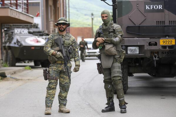German KFOR soldiers guard municipal building after yesterday's clashes between ethnic Serbs and troops from the NATO-led KFOR peacekeeping force, in the town of Zvecan, northern Kosovo, Tuesday, May 30, 2023. The violence was the latest incident as tensions soared over the past week, with Serbia putting the country's military on high alert and sending more troops to the border with Kosovo, which declared independence from Belgrade in 2008. (AP Photo/Bojan Slavkovic)
