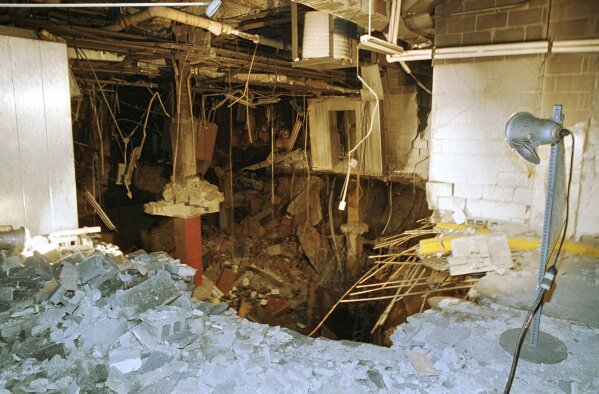 FILE - The crater in an underground parking garage from the World Trade Center explosion is shown in this Feb. 27, 1993 photo. New York City is marking the anniversary of the 1993 bombing that blew apart a van parked in an underground garage, killing six people and injured more than 1,000. The Port Authority of New York and New Jersey is holding a memorial Mass on Monday, Feb. 26, 2024 at St. Peter’s Church in Manhattan. (AP Photo/Richard Drew, file)