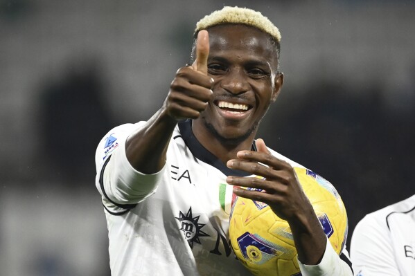 Napoli's Victor Osimhen gives the thumb up sign after he scored a hat trick during the Serie A soccer match between Sassuolo and Napoli at Mapei Stadium, Reggio Emilia, Italy, Wednesday Feb. 28, 2024. (Massimo Paolone/LaPresse via AP)