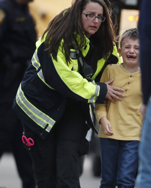 
              A young boy is led from a bus to a recreation center where students were reunited with their parents after a shooting at a suburban Denver middle school Tuesday, May 7, 2019, in Highlands Ranch, Colo. (AP Photo/David Zalubowski)
            