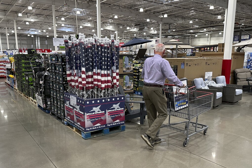 A shopper moves past a display of items in a Costco warehouse Saturday, May 18, 2024, in Sheridan, Colo. As many Americans celebrate Memorial Day on Monday, May 27, 2024, there are several stores, government offices and businesses that will be open or closed.(AP Photo/David Zalubowski)