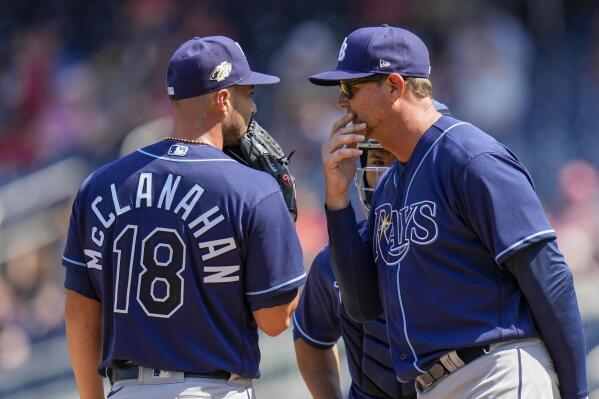 Tampa Bay Rays pitching coach Kyle Snyder, left, looks on as Shane