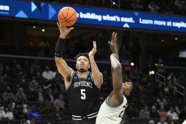 Providence forward Ed Croswell (5) goes to the basket against Georgetown forward Bradley Ezewiro (22) during the first half of an NCAA college basketball game, Sunday, Feb. 26, 2023, in Washington. (AP Photo/Nick Wass)