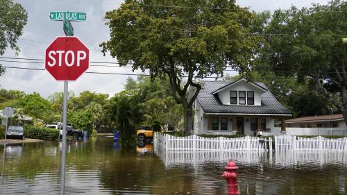 FILE - Receding floodwaters surround a home on Las Olas (Spanish for "The Waves") Boulevard in the Sailboat Bend neighborhood of in Fort Lauderdale, Fla., Thursday, April 13, 2023. President Joe Biden declared Florida's Broward County a disaster area Friday, April 28, two weeks after record-breaking rain left parts of Fort Lauderdale and its suburbs flooded. (AP Photo/Rebecca Blackwell, File)